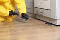 Pest control worker spraying pesticide indoors, closeup Royalty Free Stock Photo