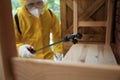 Pest control worker spraying pesticide indoors, focus on nozzle Royalty Free Stock Photo