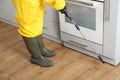 Pest control worker spraying pesticide in kitchen, closeup Royalty Free Stock Photo