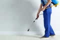 Pest control worker spraying pesticide in room. Space for text Royalty Free Stock Photo