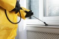 Pest control worker spraying pesticide on window sill, closeup Royalty Free Stock Photo