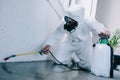 pest control worker spraying pesticides on floor