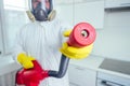 Pest control worker standing with sprayer in kitchen Royalty Free Stock Photo