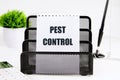 Pest Control written on a piece of paper on a white background Royalty Free Stock Photo