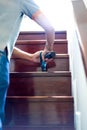 Pest termites control services on wood stair in the new house that have termites signs inside it. focus on staff`s hand