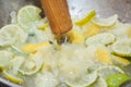 Pestling lime with lemons