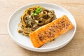 Pesto fettuccine spaghetti pasta with grilled salmon fillet