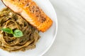 Pesto fettuccine spaghetti pasta with grilled salmon fillet