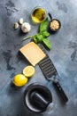 Pesto genovese sauce Ingredients italian recipe Fresh basil, tomatoes mortar lemon olive oil parmesan pine nuts on the stone table Royalty Free Stock Photo