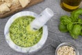 Pesto sauce. Italian pesto prepared in a marble mortar with pestle. Royalty Free Stock Photo