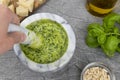 Pesto sauce. Italian pesto prepared in a marble mortar with pestle. Royalty Free Stock Photo