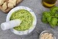 Pesto sauce. Italian pesto prepared in a marble mortar with pestle. Royalty Free Stock Photo