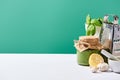 Pesto sauce in jar near ingredients and grater on white table isolated on green Royalty Free Stock Photo