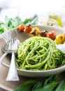 Pesto spaghetti with grilled tomatoes Royalty Free Stock Photo