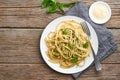 Pesto spaghetti pasta with basil, garlic, pine nuts, olive oil. Copy space. Rustic table Royalty Free Stock Photo