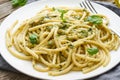 Pesto spaghetti pasta with basil, garlic, pine nuts, olive oil. Rustic table, close up Royalty Free Stock Photo