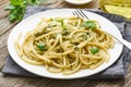 Pesto spaghetti pasta with basil, garlic, pine nuts, olive oil. Rustic table, close up Royalty Free Stock Photo