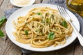 Pesto spaghetti pasta with basil, garlic, pine nuts, olive oil. Rustic table, side view Royalty Free Stock Photo