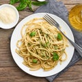 Pesto spaghetti pasta with basil, garlic, pine nuts, olive oil. Rustic table Royalty Free Stock Photo