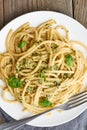 Pesto spaghetti pasta with basil, garlic, pine nuts, olive oil. Vertical. Rustic table Royalty Free Stock Photo