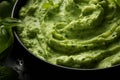 Pesto spread texture background. Green Italian homemade spilled sauce made of ground basil, garlic, pine seeds, olives and