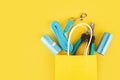 pet accessories, dog and cat tools in a shopping bag on a yellow background, copy space, top view, flat lay Royalty Free Stock Photo