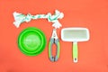 Pet accessories of green concept : Bowl, Nail scissors, brush Royalty Free Stock Photo