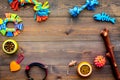 Pet accessories. Toys near bowls with animal feed, collar on dark wooden background top view copy space