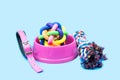 Pet bowl, Rope, rubber ball and collars on light blue background.