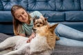 Young woman playing with her dogs at home Royalty Free Stock Photo