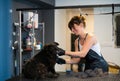 Pet hairdresser woman cutting fur of cute black dog Royalty Free Stock Photo