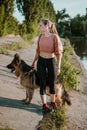 Pet Love. Young pretty happy woman plays with German Shepherd dog. Authentic moments of joy girl playing with her dogs. Pet love, Royalty Free Stock Photo