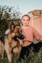 Pet Love. Young pretty happy woman plays with German Shepherd dog. Authentic moments of joy girl playing with her dogs. Pet love, Royalty Free Stock Photo