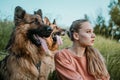 Pet Love. Young pretty happy woman plays with German Shepherd dog. Authentic moments of joy girl playing with her dogs. Pet love, Royalty Free Stock Photo