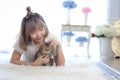 Pet Lover concept. Cat in the embrace of the woman lying on the wool carpet. Young Female lying in bed and holding her beautiful Royalty Free Stock Photo