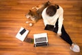 Pet Lover concept. Work from home and pets. Top view. Japanese dog and Young woman working with a laptop on the wooden floor. Royalty Free Stock Photo