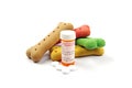 Pet medication and pill container with colored dog bone treats Royalty Free Stock Photo