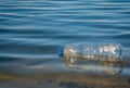 A PET plastic bottle floating on water of a lake in Bucharest, Romania. Plastic pollution concept