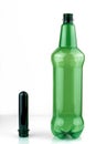 PET preforms and a green plastic bottle. Blank for a plastic bottle, on a white background Royalty Free Stock Photo