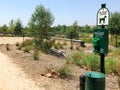 Pet Waste Station sign with bags and fenced field