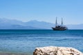 PETALIDI, GREECE - AUGUST 13, 2017: Tourists enjoying sea journey on vintage sail ship in Petalidi village, Greece
