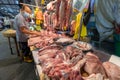 Butcher preparing meats at morning wet market