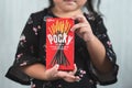 Little asian girl holding a box of pocky brand of chocolate sticks.