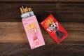 Pocky brand of chocolate sticks on wooden background.