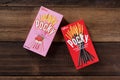 Pocky brand of chocolate sticks on wooden background.