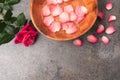 Petals in wooden bowls. Spread rose petals together with a flower. Royalty Free Stock Photo