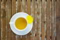 Petals of Yellow Silk Cotton flower & cup of tea on ceramic dis Royalty Free Stock Photo