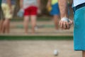 Petanque ball in hand of man