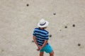 petanque player with white hat in the bowling alley in summer Royalty Free Stock Photo