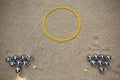 Petanque set with nineteen metal balls in field for game Royalty Free Stock Photo